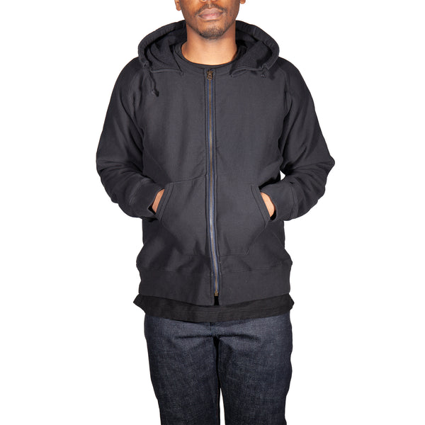 Person wearing a black hoodie on a white background