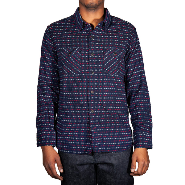 Man wearing a patterned shirt on a white background