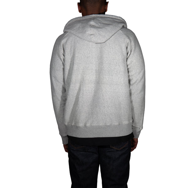 Person wearing a gray hoodie from behind on a white background