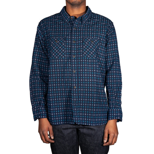 Man wearing a blue checkered shirt on a white background