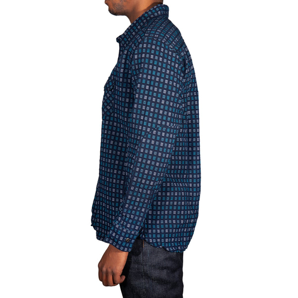 Person wearing a blue checkered shirt on a white background