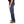 Person wearing blue jeans and brown shoes on a white background