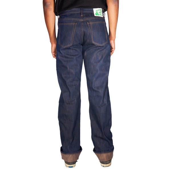 Person wearing dark blue jeans on a white background