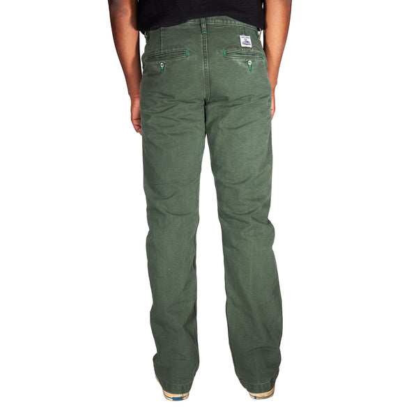 Green pants worn by a person on a white background