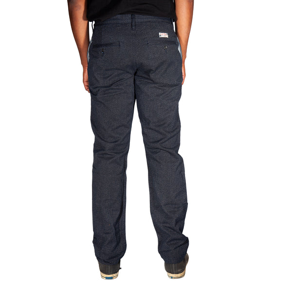 Person wearing dark gray pants on a white background