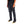 Person wearing dark jeans and black sneakers on a white background
