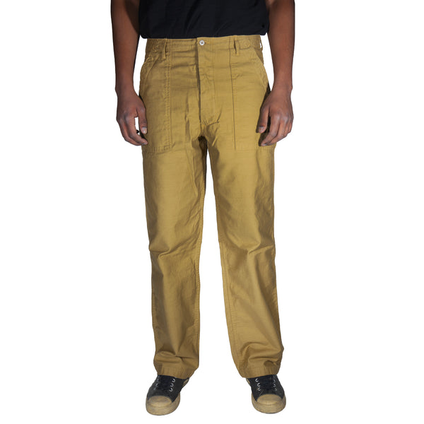 Beige pants worn by a person on a white background