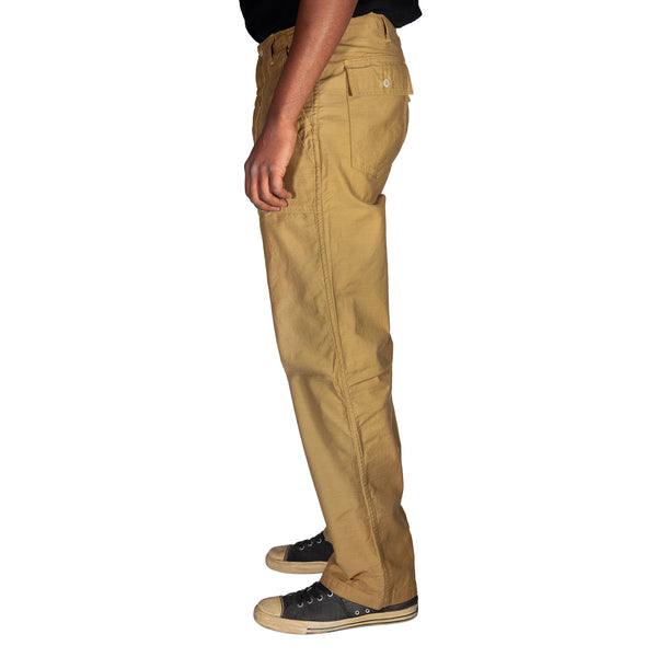 Beige pants worn by a person on a white background