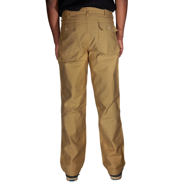 Tan pants worn by a person on a white background