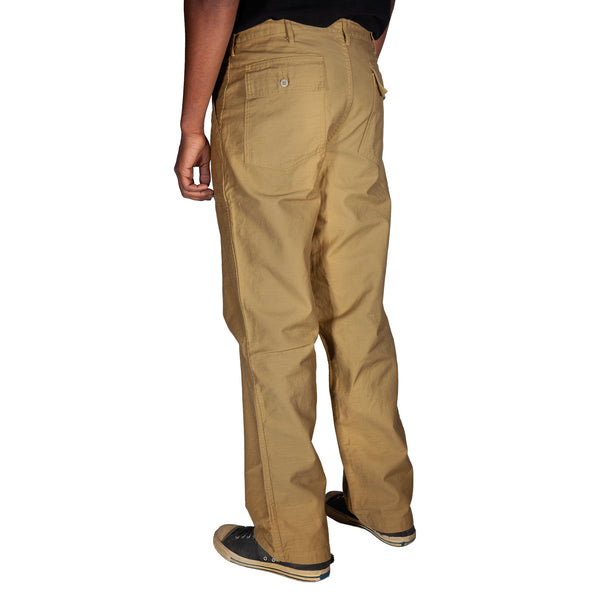 Beige pants worn by a person on a white background