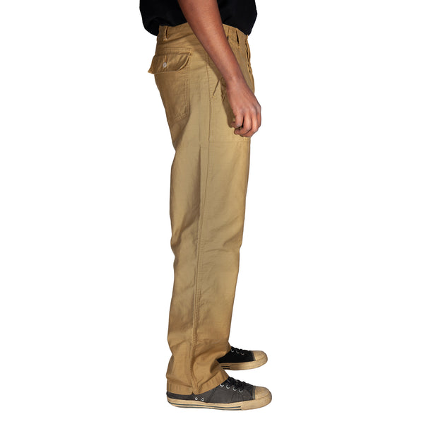 Beige pants worn by a person on a white background