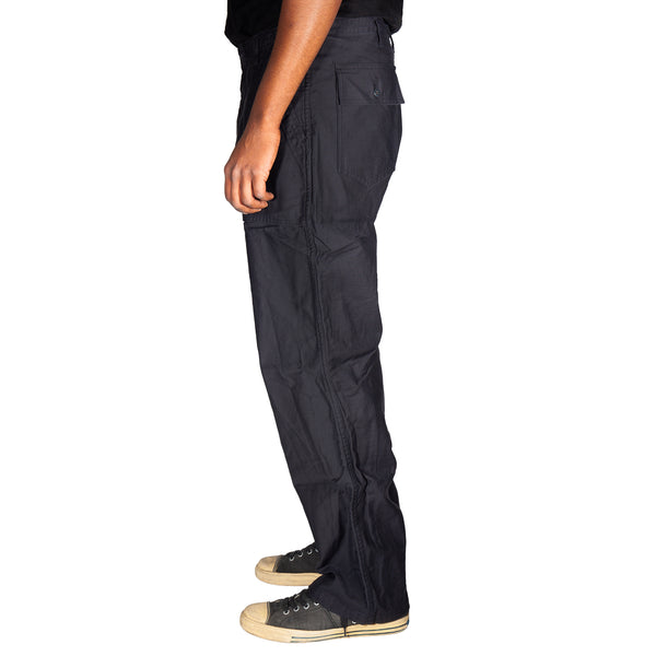 Black cargo pants worn by a person on a white background