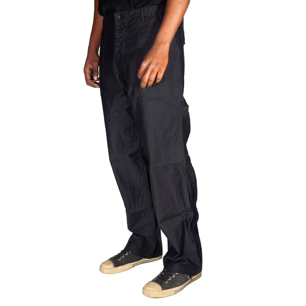 Person wearing black cargo pants on a white background