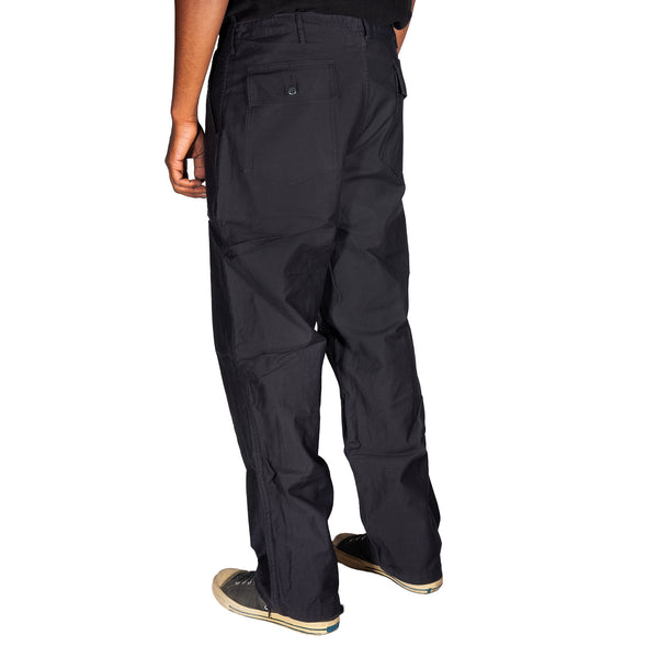 Black pants worn by a person on a white background