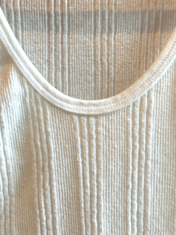 A white Japanese drop needle tank top with a slubby textured fabric,