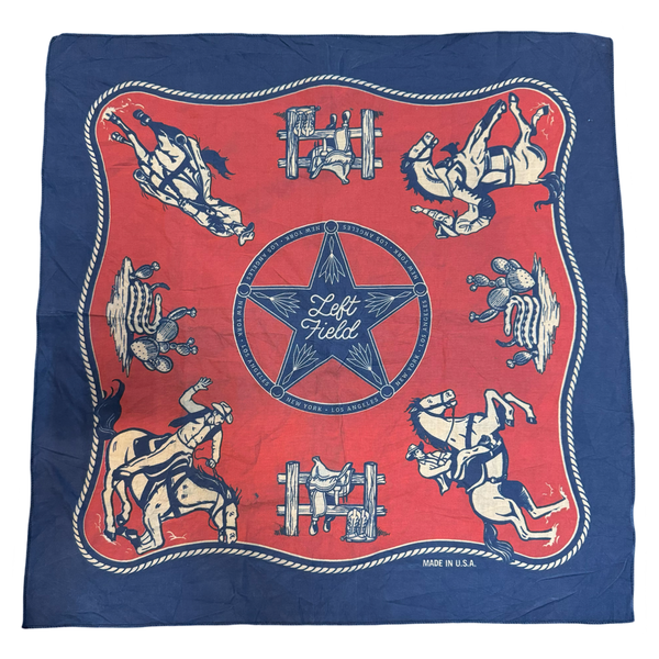 A red and blue bandana with a rotary print featuring horses cowboy and the brand 'Left Field'.