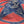 A red and blue bandana with a rotary print featuring horses cowboy and the brand 'Left Field'.