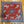 A red and blue bandana with a rotary print featuring horses cowboy and the brand 'Left Field' backside