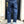 Person wearing blue jeans standing in front of a door.