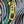 Close-up of a brass zipper pull on striped fabric