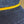 Close-up of a textured fabric with yellow trim on a wooden surface