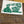 Green and white patch with text and graphics on a textured surface