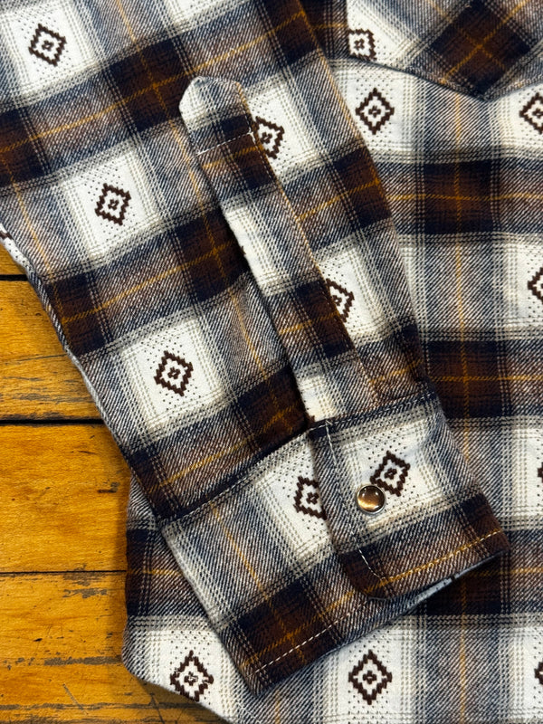 Plaid fabric with geometric patterns on a wooden surface