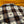 Plaid blanket with geometric patterns on a wooden floor