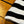 Close-up of a black and white striped sock on a wooden floor.