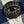 Close-up of a button with 'Left Field' branding on a checkered fabric background