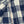 Close-up of blue and white checkered fabric with stitching detail selvedge