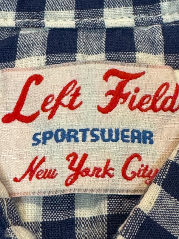 Label on a plaid shirt with text 'Left Field Sportswear New York City'.