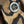 Close-up of a four-button fabric button on a brown and black leopard-print textile.