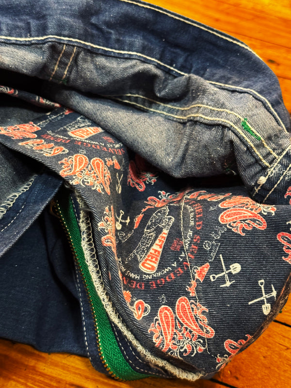 Stack of jeans with patterned waistband on a wooden surface
