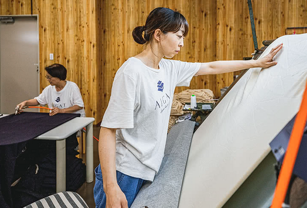 worker making fabric tee