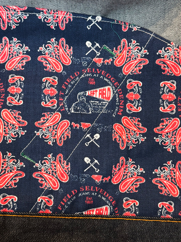 Close-up of denim fabric with red and white pattern 