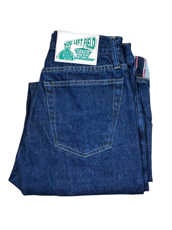 Folded blue jeans with a 'Left Field' label on a white background