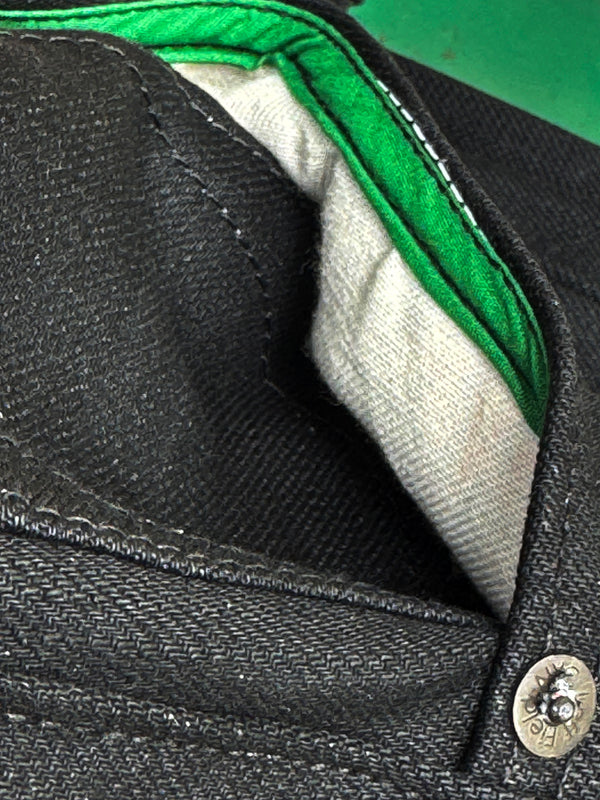 Close-up of a green lining and button detail.