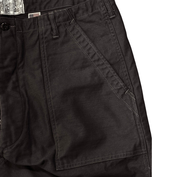 A pair of black chino trousers with front and back patch pockets