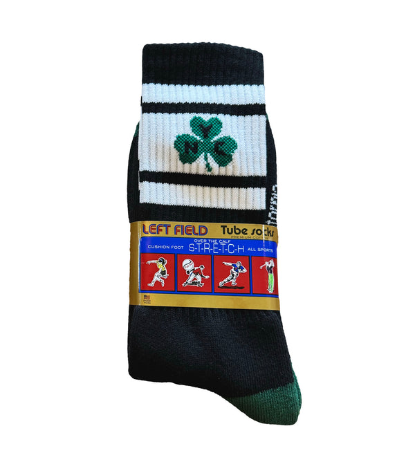 A pair of black and white striped bamboo tube socks with a green shamrock design on the ankle area, and additional colorful graphics and text on the lower leg.
