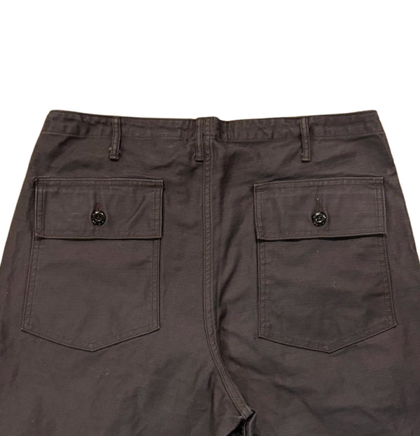 A pair of faded slate gray/black chinos with front and back patch pockets, high-rise waist, and long button front fly.