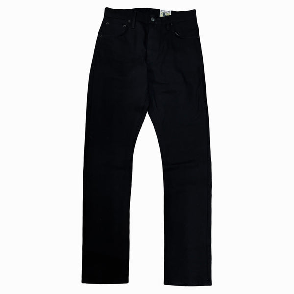 A pair of black denim jeans laid flat on a surface.