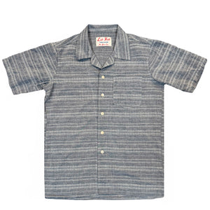 A short-sleeved camp shirt with Trocus pearl buttons, collar, and a pocket on the chest, in a striped pattern.
