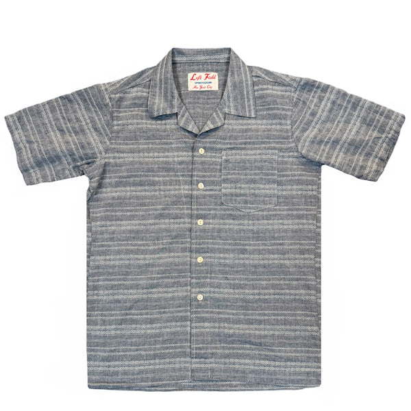A short-sleeved camp shirt with Trocus pearl buttons, collar, and a pocket on the chest, in a striped pattern.