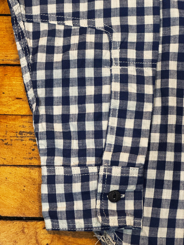Close-up of a blue and white checkered shirt on a wooden surface