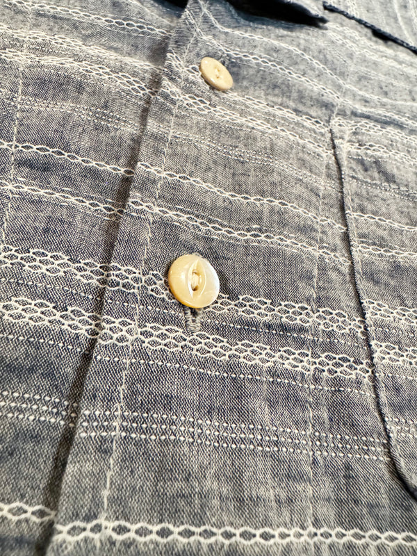 A short-sleeved camp shirt with Trocus pearl buttons, collar, and a pocket on the chest, in a striped pattern.