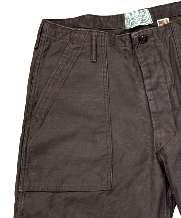 A pair of faded slate gray/black chinos with front and back patch pockets, high-rise waist, and long button front fly.