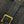 Close-up of a black denim belt with gold buckle and stitching