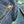 Close-up of a button on a denim fabric with green accents