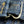 Close-up of a blue denim fabric with gold stitching and a zipper.